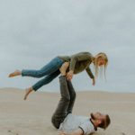 Playful Couple on Dunes // SLO elopement photographer